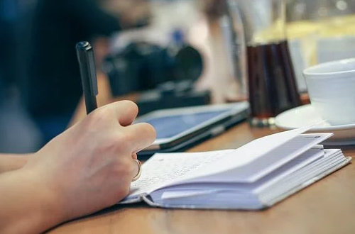 A person making a note in a notebook.