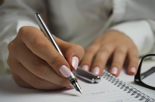 The woman is taking notes.