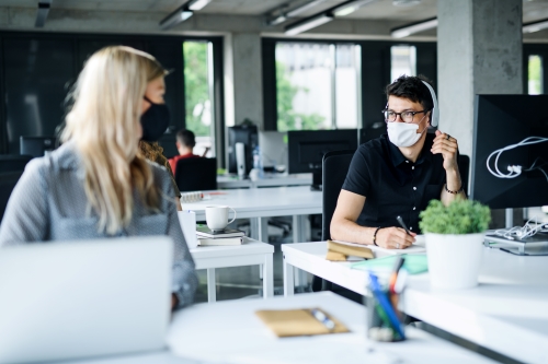 Office workers in hygienic masks.